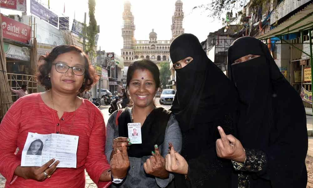 People proudly displaying the marks on their fingers after casting ...