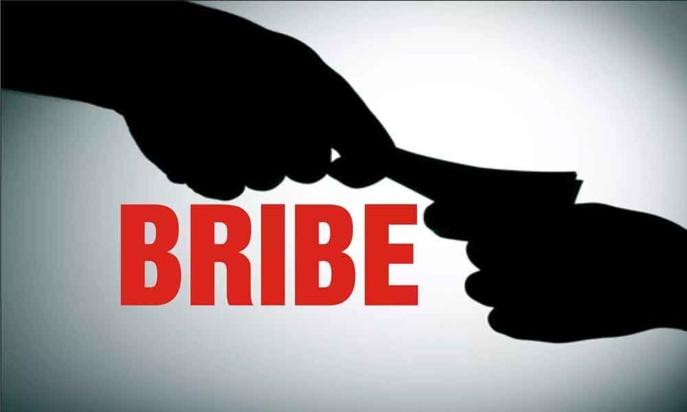 Stung by KCRs corrupt jibe : Revenue staff erect board asking people   to complain if they demand bribe