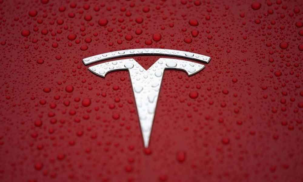 Ending tough week, Tesla shares sink to lowest in two years