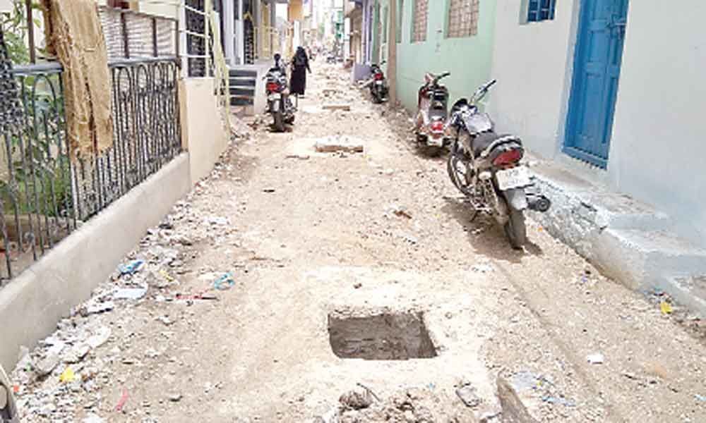 Damaged roads, open manhole pose danger