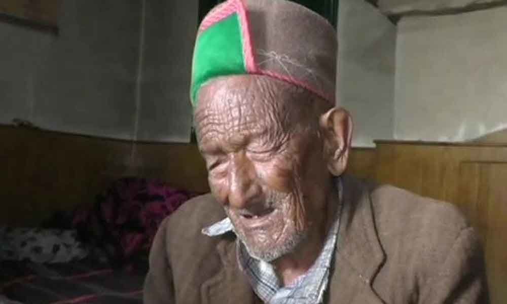 A 102-year-old voter casts ballot in Himachal