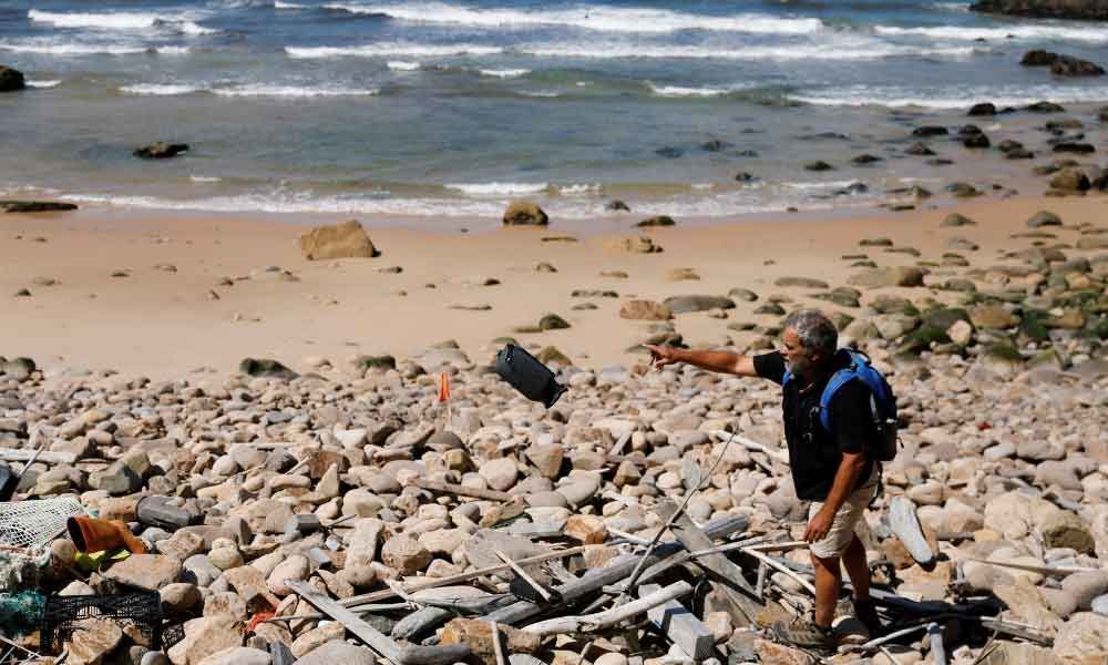 In Portugal, a man braves dangerous cliffs to clean-up the coast
