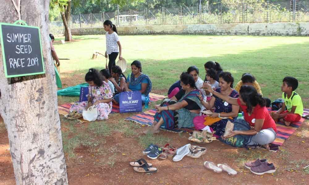 Children collect seeds from Sanjeevaiah Park