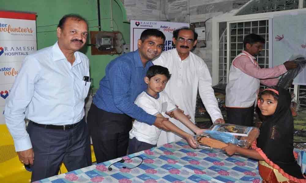 School bags, food packets distributed to 100 children