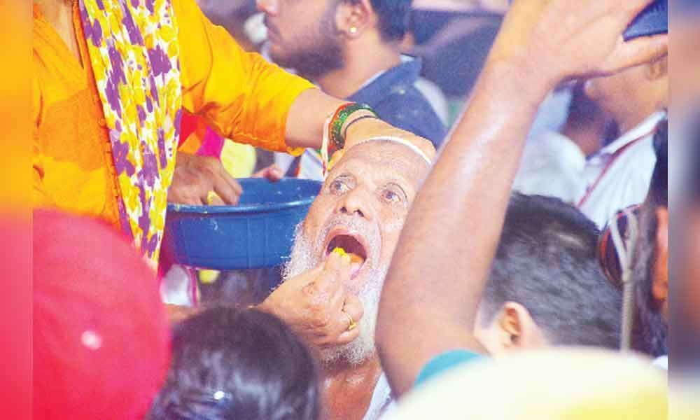 Thousands take fish prasadam