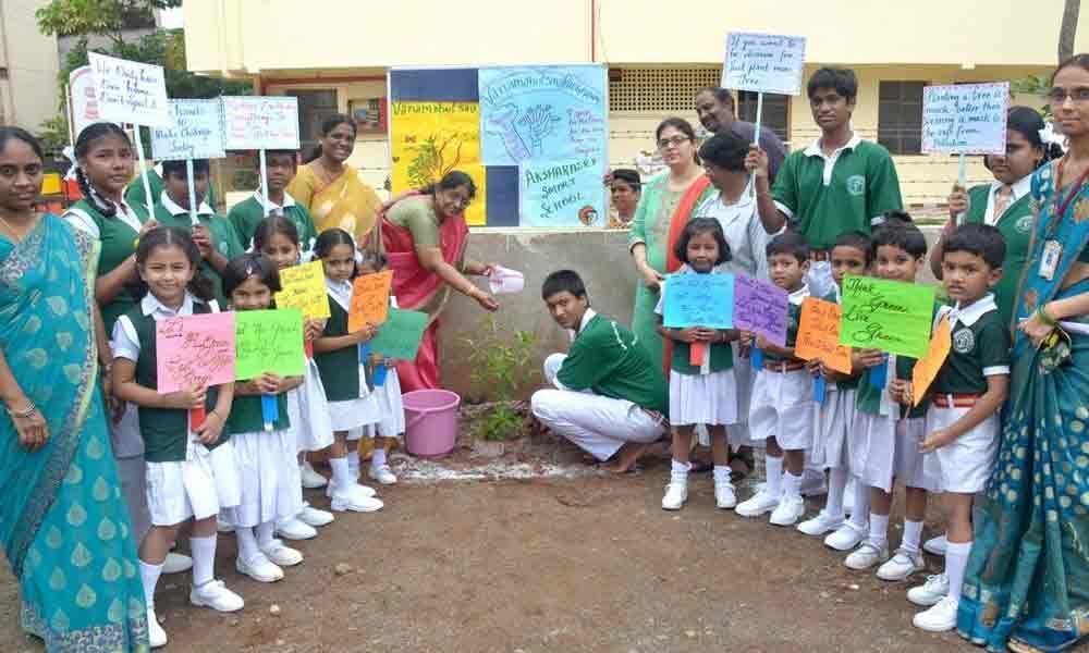 Students plant saplings in Aksharasri Smart School