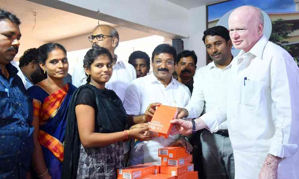 Deputy CM distributes tabs to students in Bhushanam Zilla Parishad High School