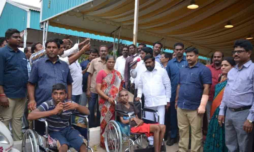 Minister distributes tricycles to differently-abled in Suryapet
