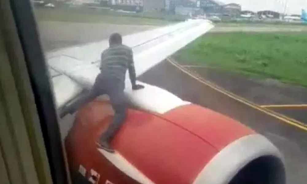 Man climbs onto plane wing before takeoff at Nigeria airport