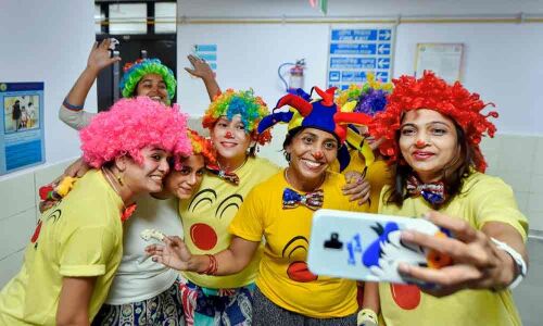 A red nose, a coloured wig, and a medical clown
