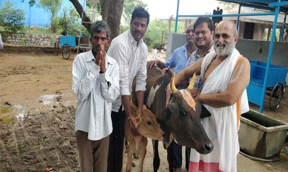Temple priests gesture to devastated farmer