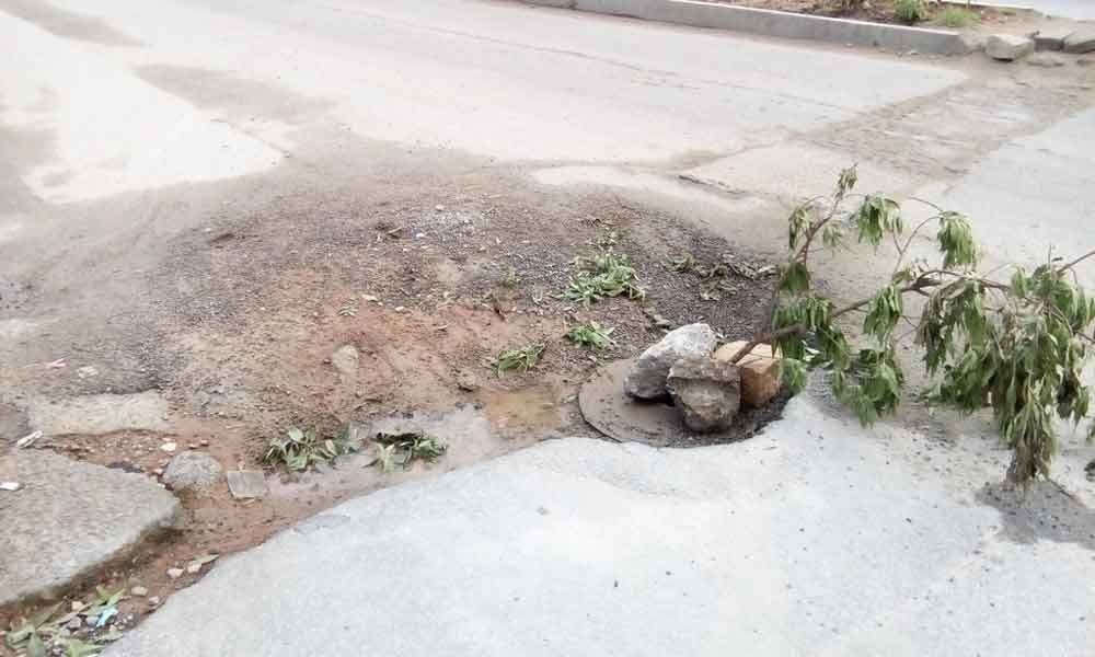 Part of road caves in, poses threat