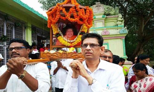 Sri Sathya Sai Baba devotees take part in Pallaki Seva