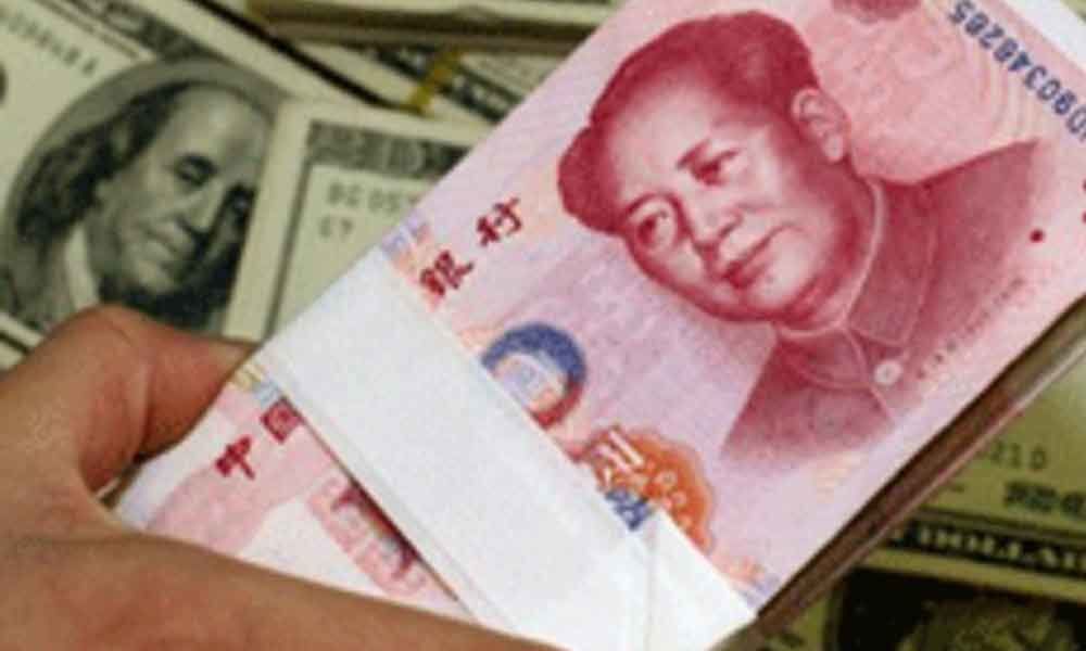 Chinas yuan falls below sensitive level of 7