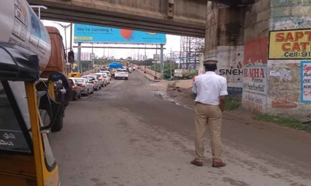 Traffic trudges on potholed road