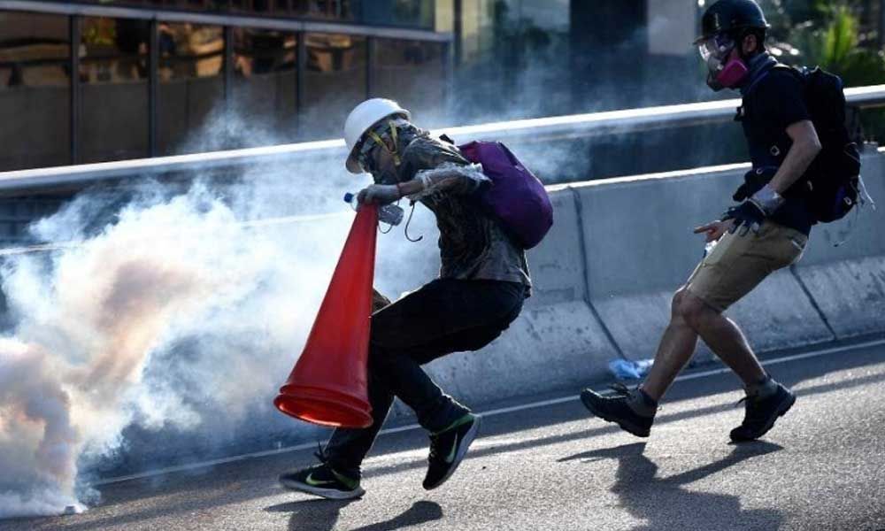 Hong Kongers harness traffic cones, kitchenware to battle tear gas