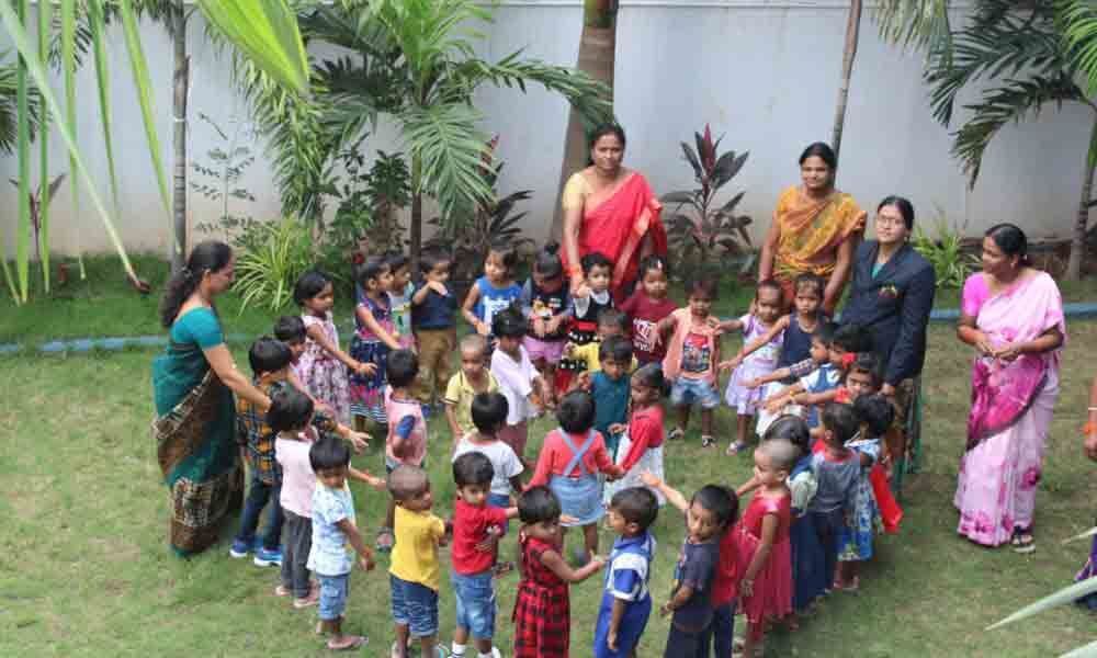 Children tie rakhis to each other in Karimnagar