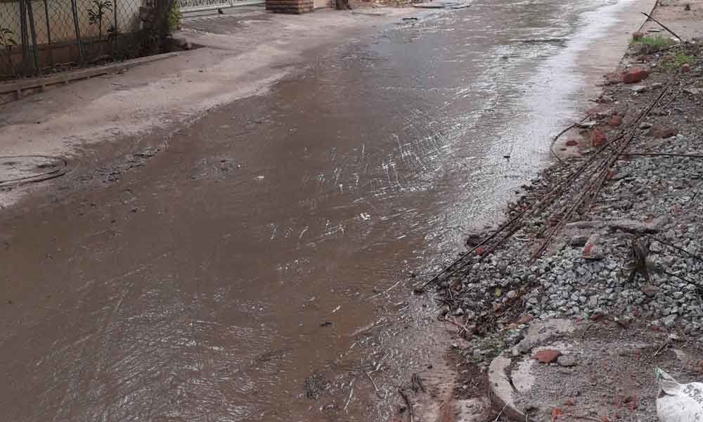 Clogged drains form dirty rivulets on roads