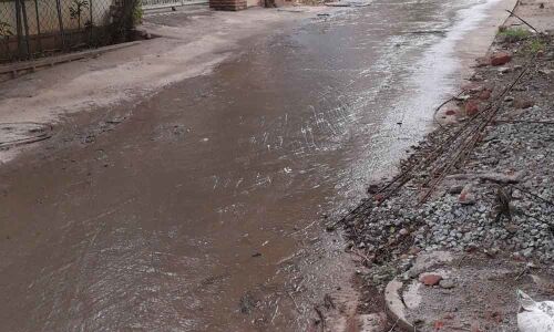Clogged drains form dirty rivulets on roads