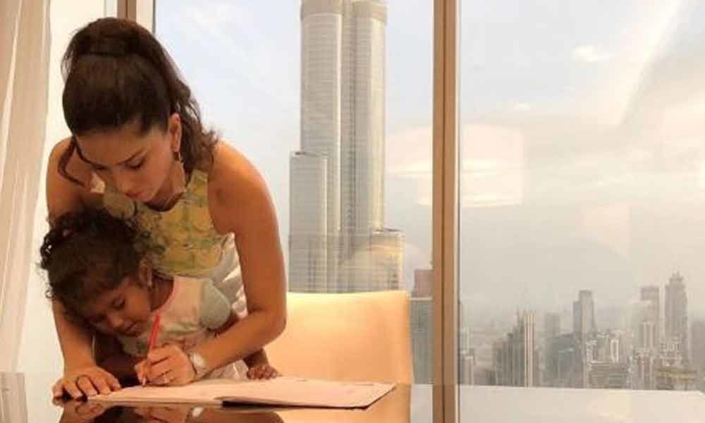 #Motherhood: Sunny Leone helps daughter finish homework