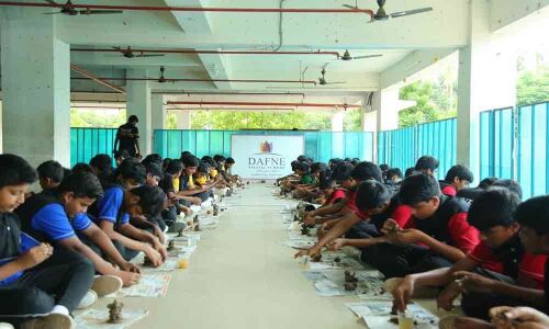 Students make clay Ganesh idols in Rajamahendravaram