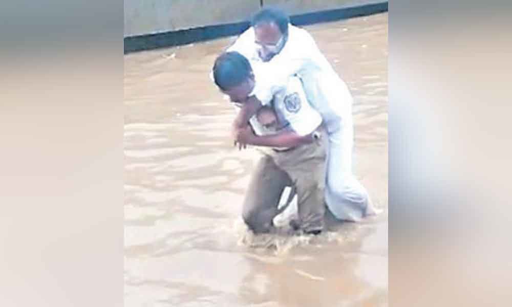 Hyderabad traffic cop praised for carrying patient on shoulders in flood water at Nagole