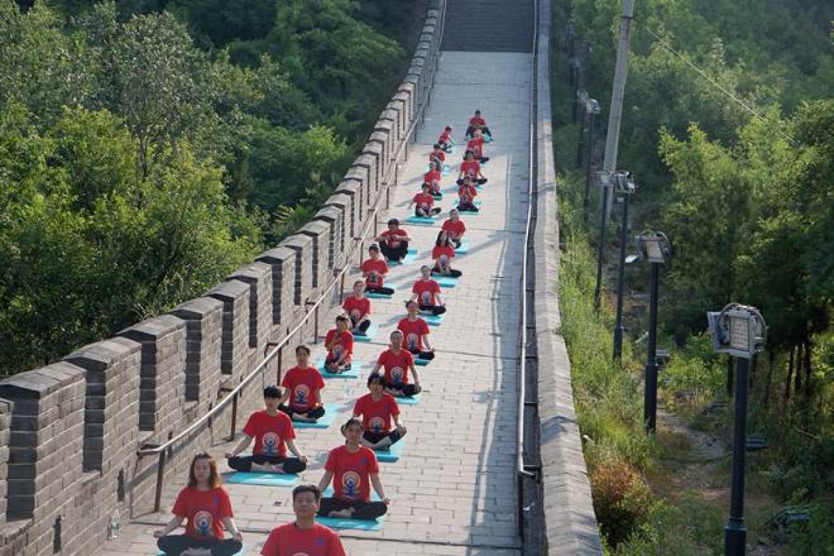 Indian And Chinese Yoga Enthusiasts Practice Poses At Great Wall Of China