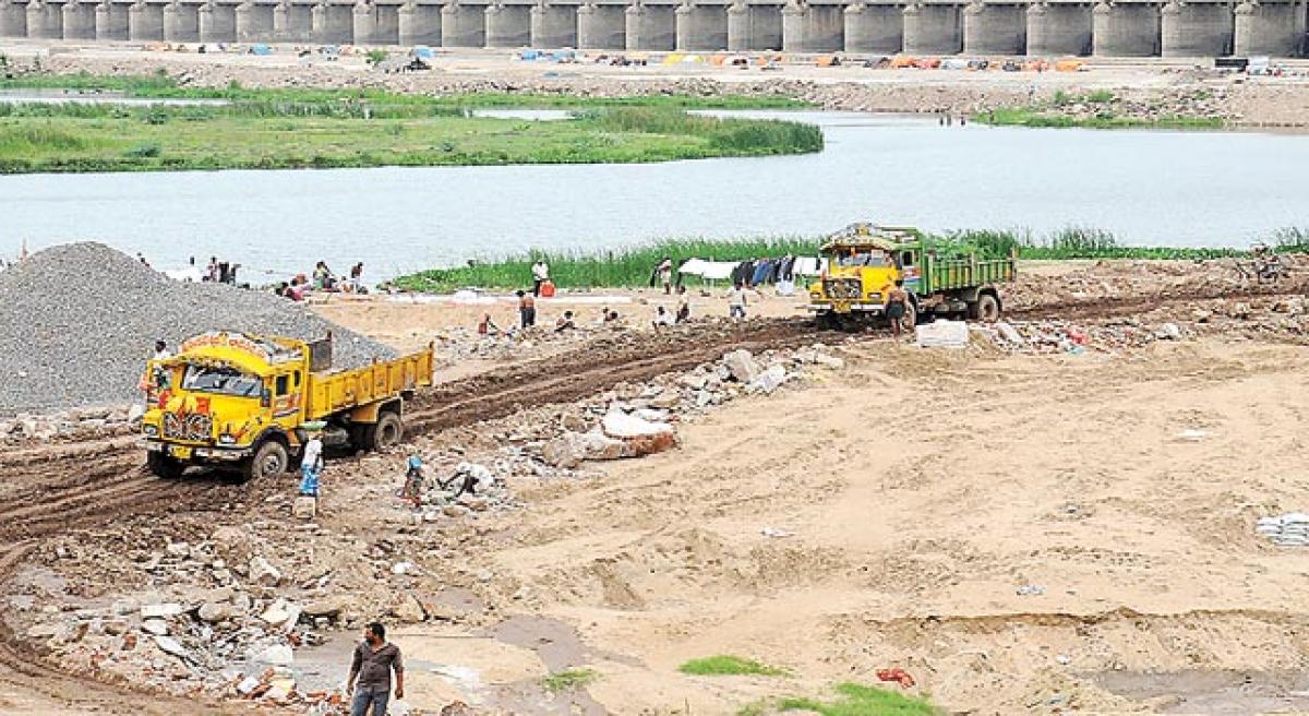 Removing debris from bathing ghats a big task.