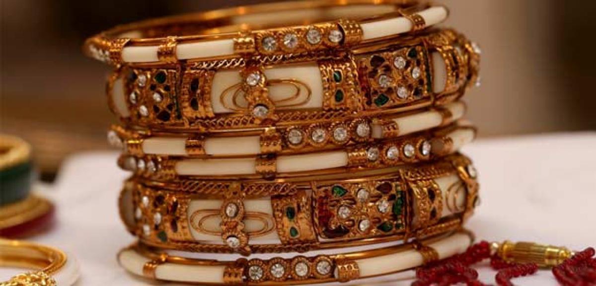 Gold weakens on muted demand; silver remains flat