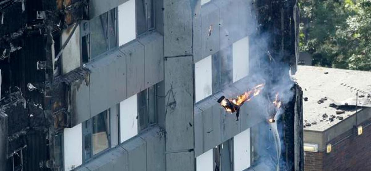 London fire: baby dropped from 10th floor caught by man on ground