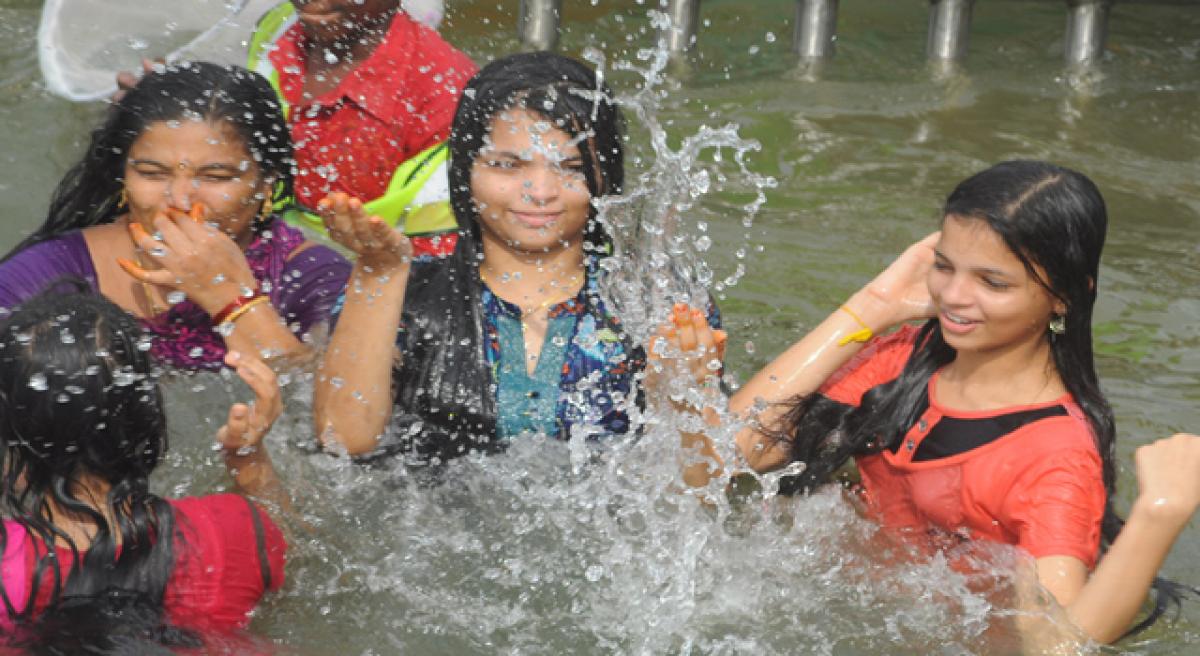 Youth enjoy at spacious ghats in Vijayawada