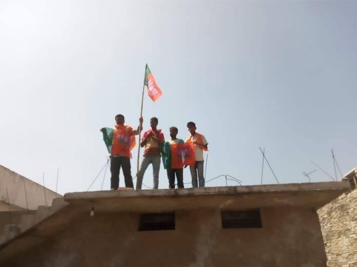 BJP activists hoist flags atop houses