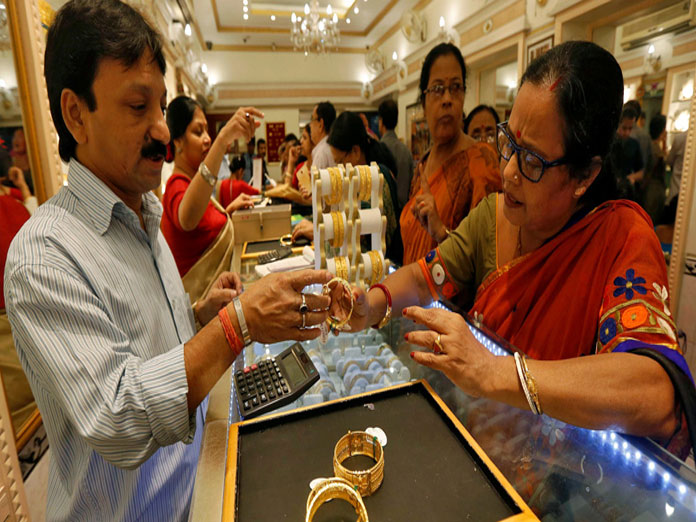 Gold falls Rs 450 on weak global cues, tepid demand