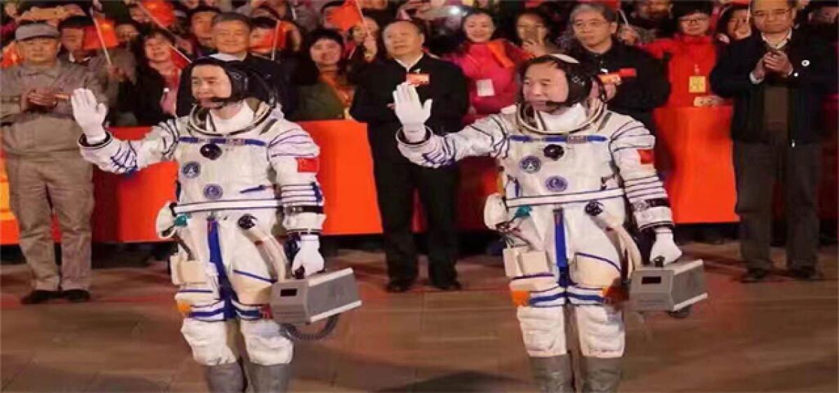 Two Chinese astronauts enter space lab after successful docking