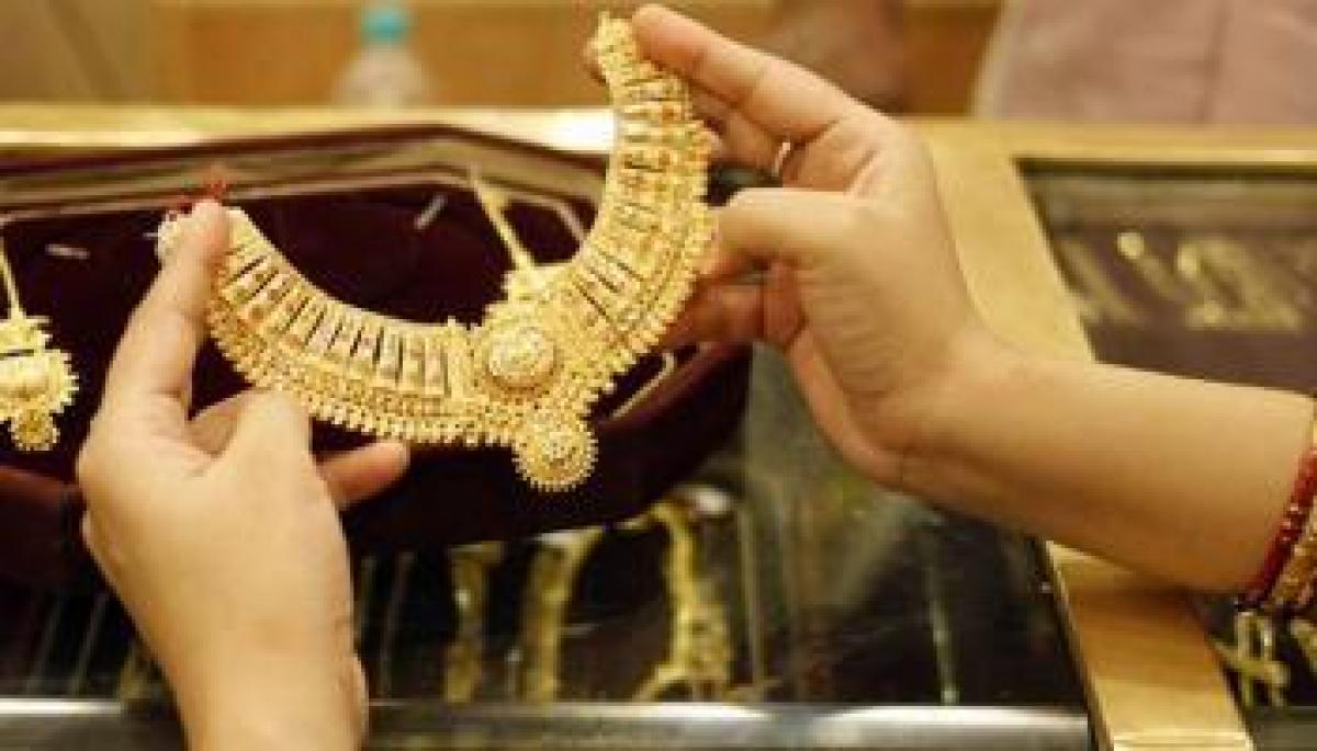 Gold futures drop Rs 136 on weak global cues, profit-booking