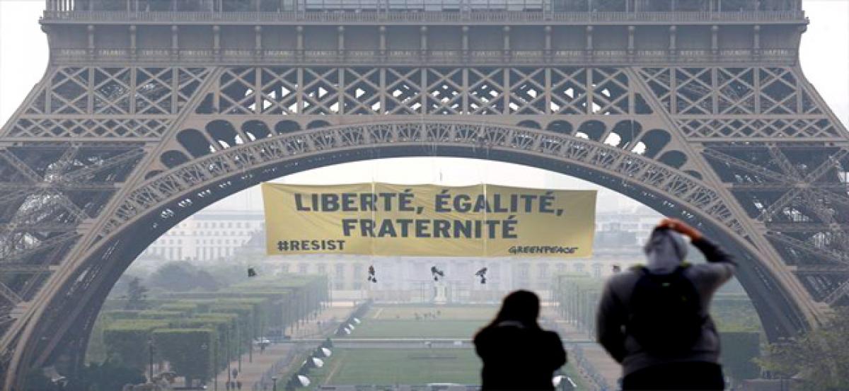 Greenpeace unfurls anti-Le Pen resist banner on Eiffel Tower