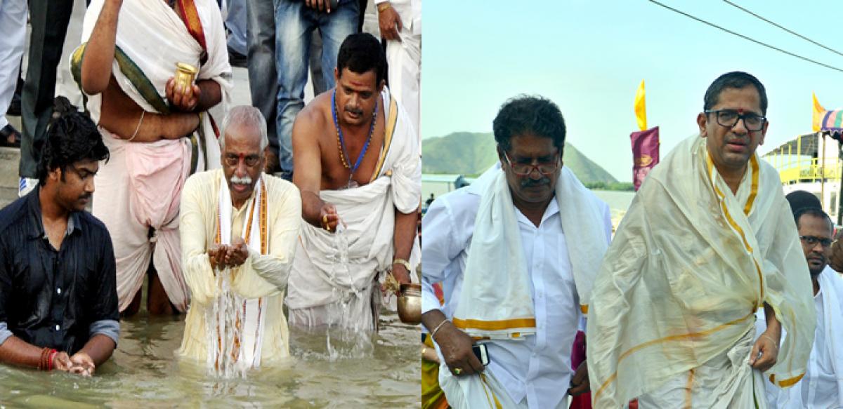 Justice N V Ramana, Dattatreya take holy dip