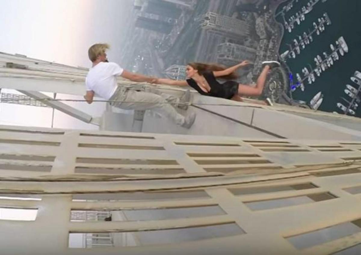 Russian model dangles from skyscraper for photoshoot; summoned by police