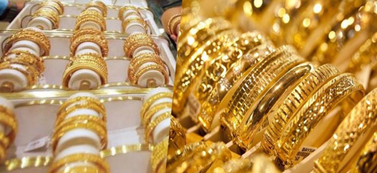 Gold edges up after falling to 10-month lows