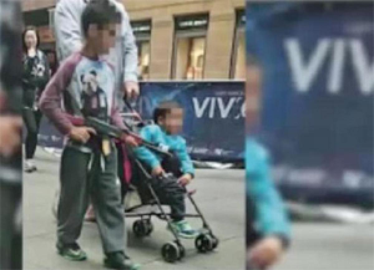 Picture of boy carrying toy gun sparks uproar in Australia