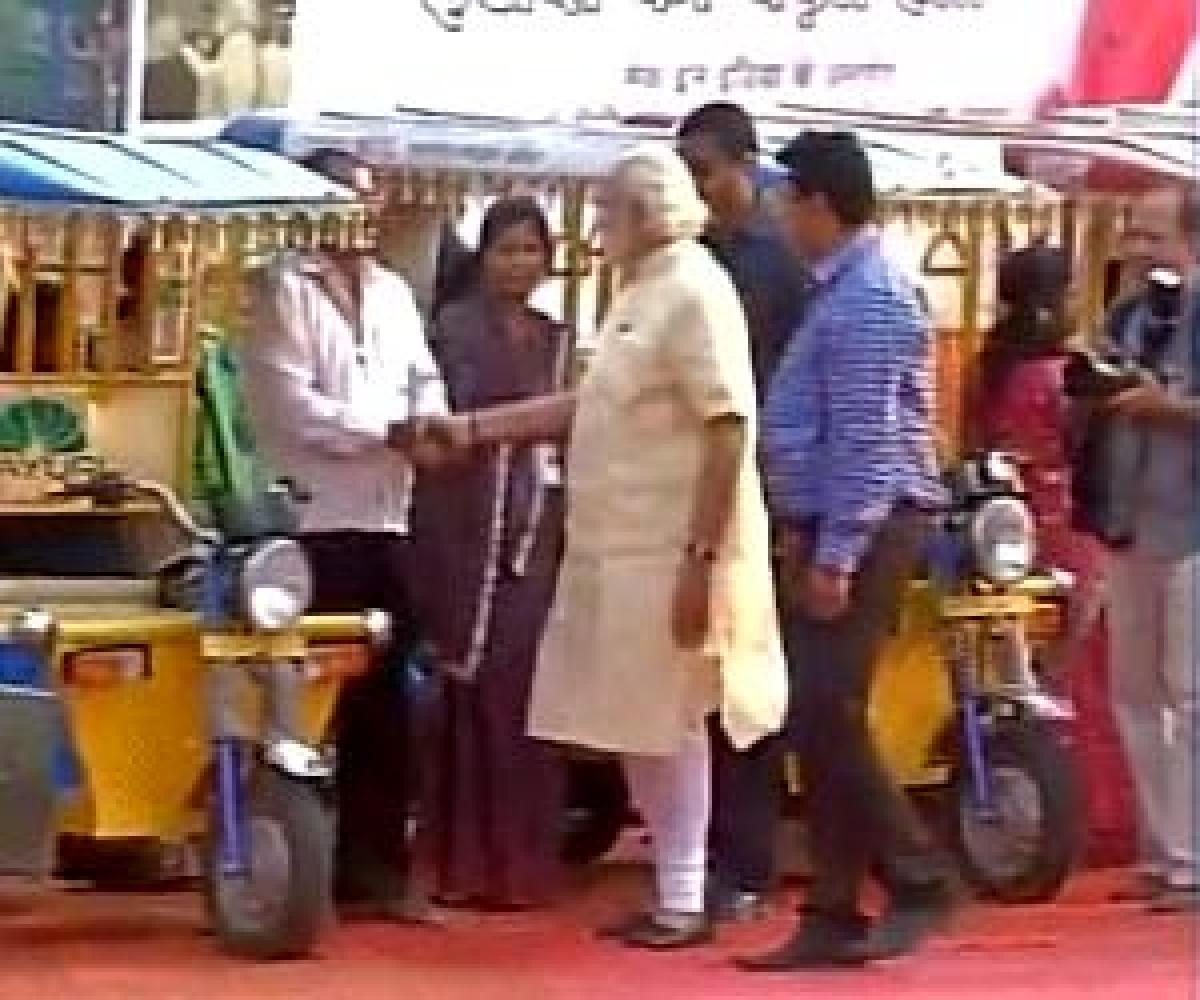 PM Modi takes a ride on e-rickshaw in Varanasi