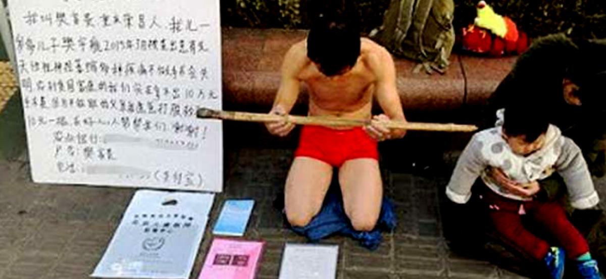 Desperate Chinese man begs to be hit to raise money for sons operation