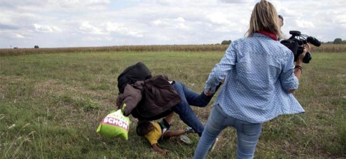 Hungary charges camerawoman accused of tripping fleeing migrants