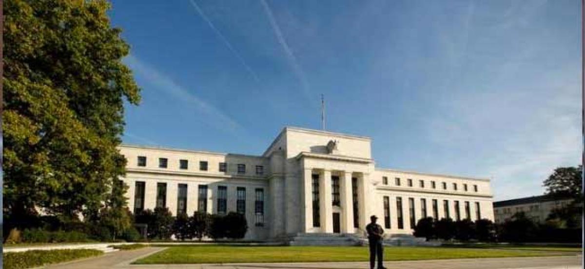 Fed holds interest rates steady, downplays economic weakness