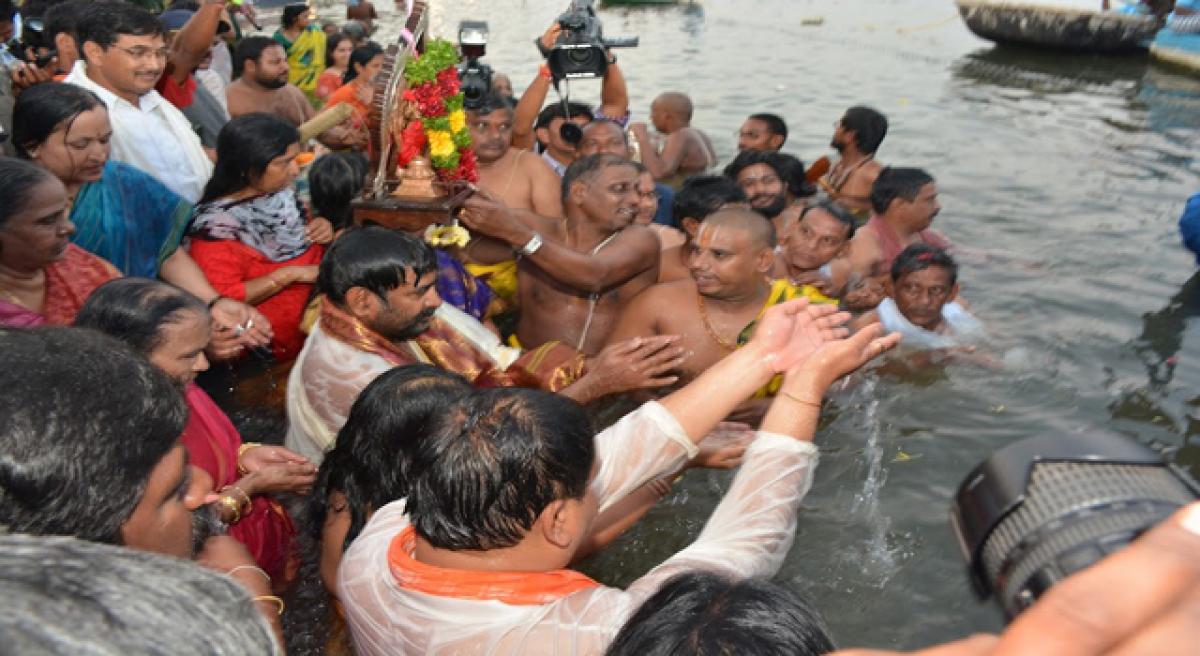 Thousands take holy dip on Day 1