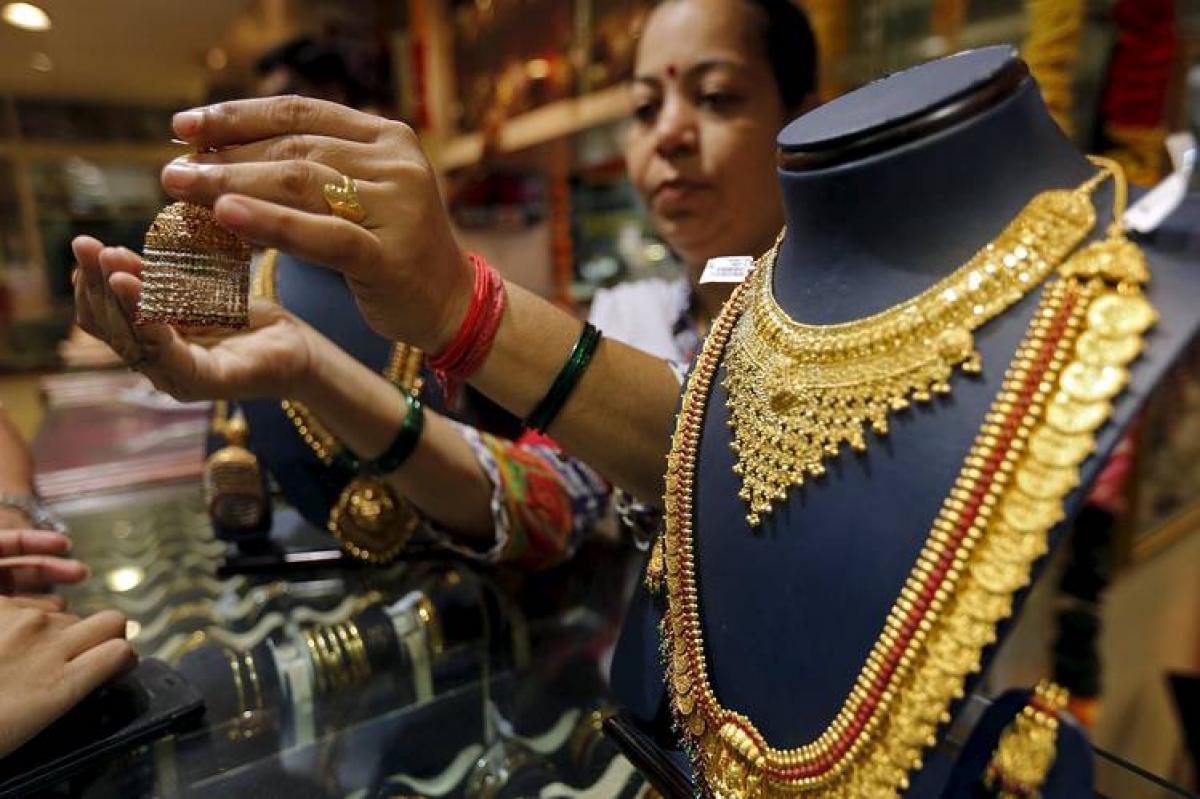 Gold slips from three-month highs on dollar strength