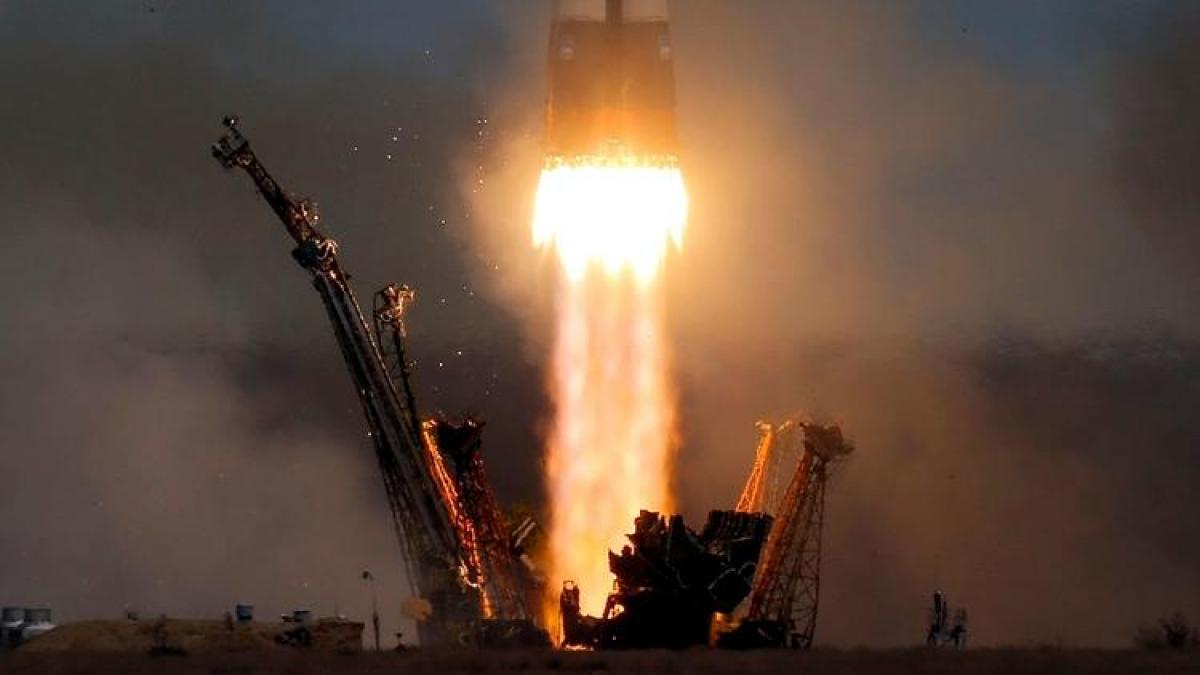 Soyuz space capsule carrying American, Russian blasts off