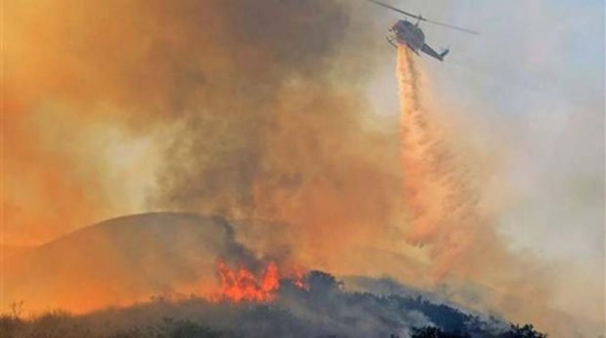 California brush fire forces evacuations, road closures