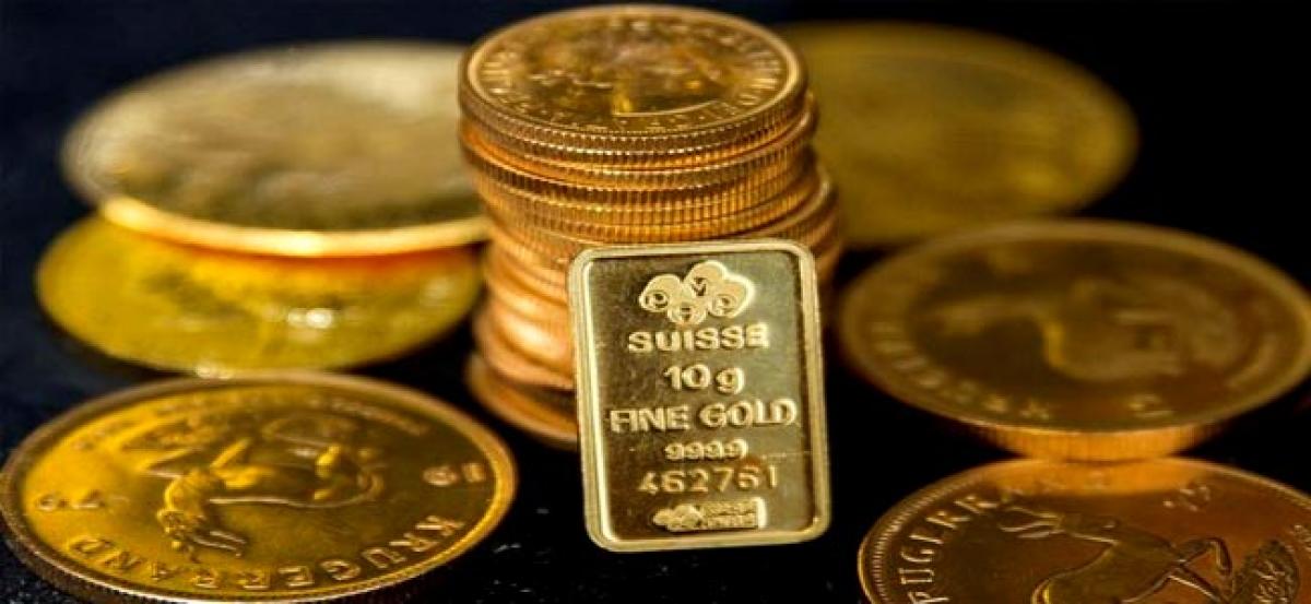 Gold edges lower, market focus turns to OPEC