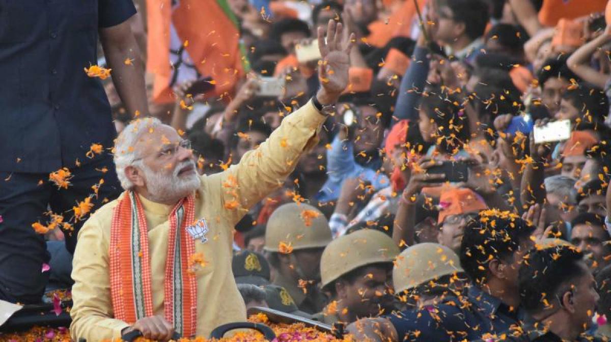 Modi battles for hearts and minds in Varanasi as analysts predict close call